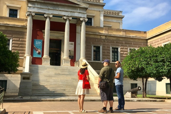 a group of people walking down a street in front of a building